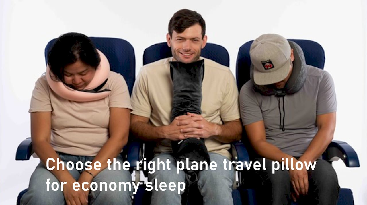 Man using travel pillow on airplane