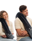 Couple using Bolstie travel pillow for long haul flight comfort without neck wrap